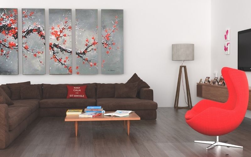 Dark wood floor with bright red furniture and pops of white